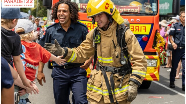 Image © Claude Thérond – used with permission Firefighters greeting children at Santa Parade, Pohutukawa Coast Christmas celebration