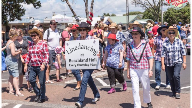 Image © Claude Thérond – used with permission Line dancing group with Beachland Hall sign in Santa Parade, Christmas celebration