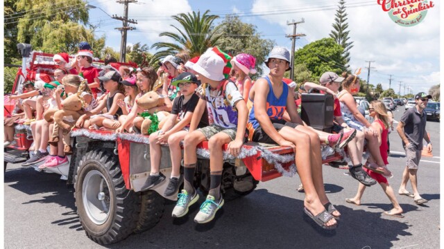 Image © Claude Thérond – used with permission Children on decorated truck float in Santa Parade, Christmas celebration