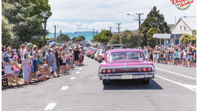 Image © Claude Thérond – used with permission Santa Parade classic car with crowds lining street, Christmas celebration