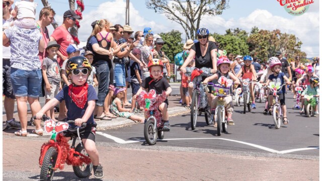 Image © Claude Thérond – used with permission Children on decorated bikes Christmas Santa Parade Pohutukawa